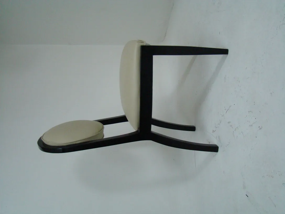 View of 12 antique chairs in a simple setting