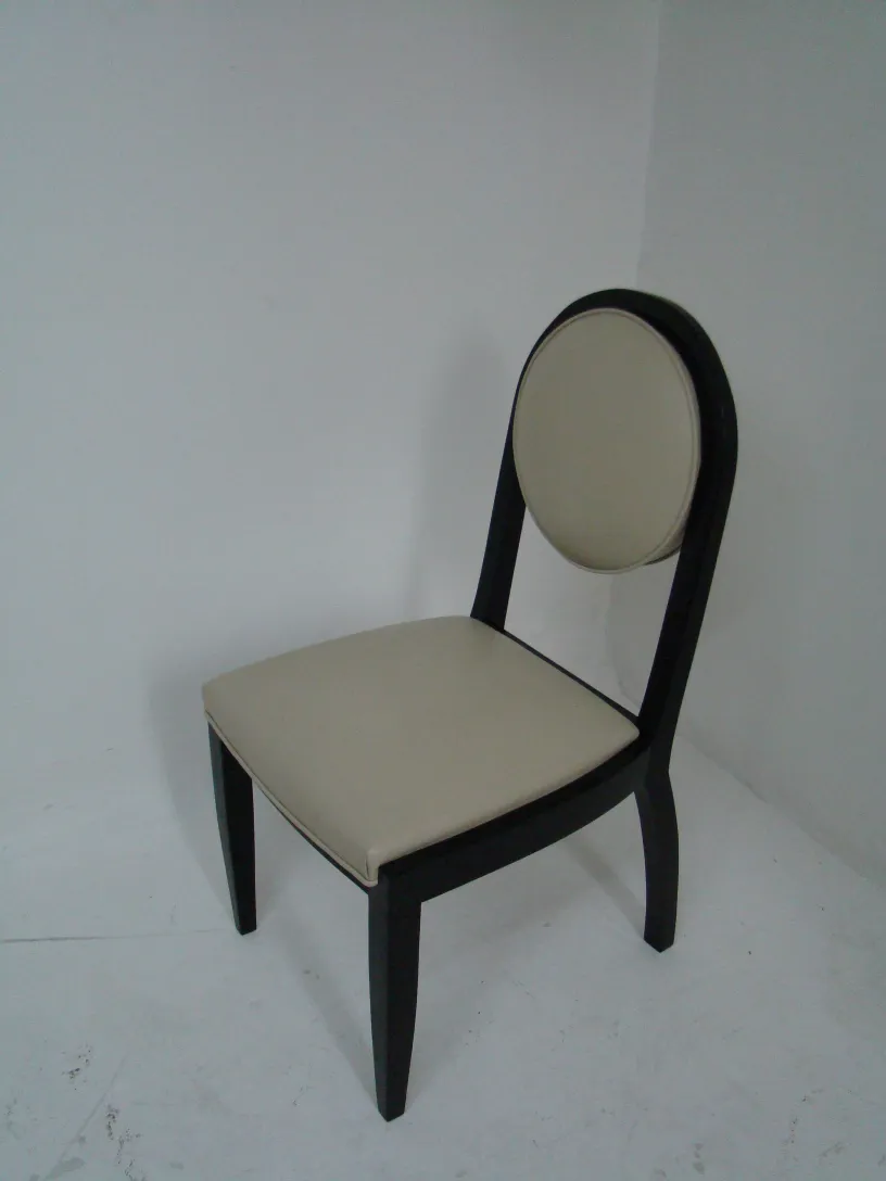 12 antique chairs in art deco style, ready for restoration in a neutral setting.