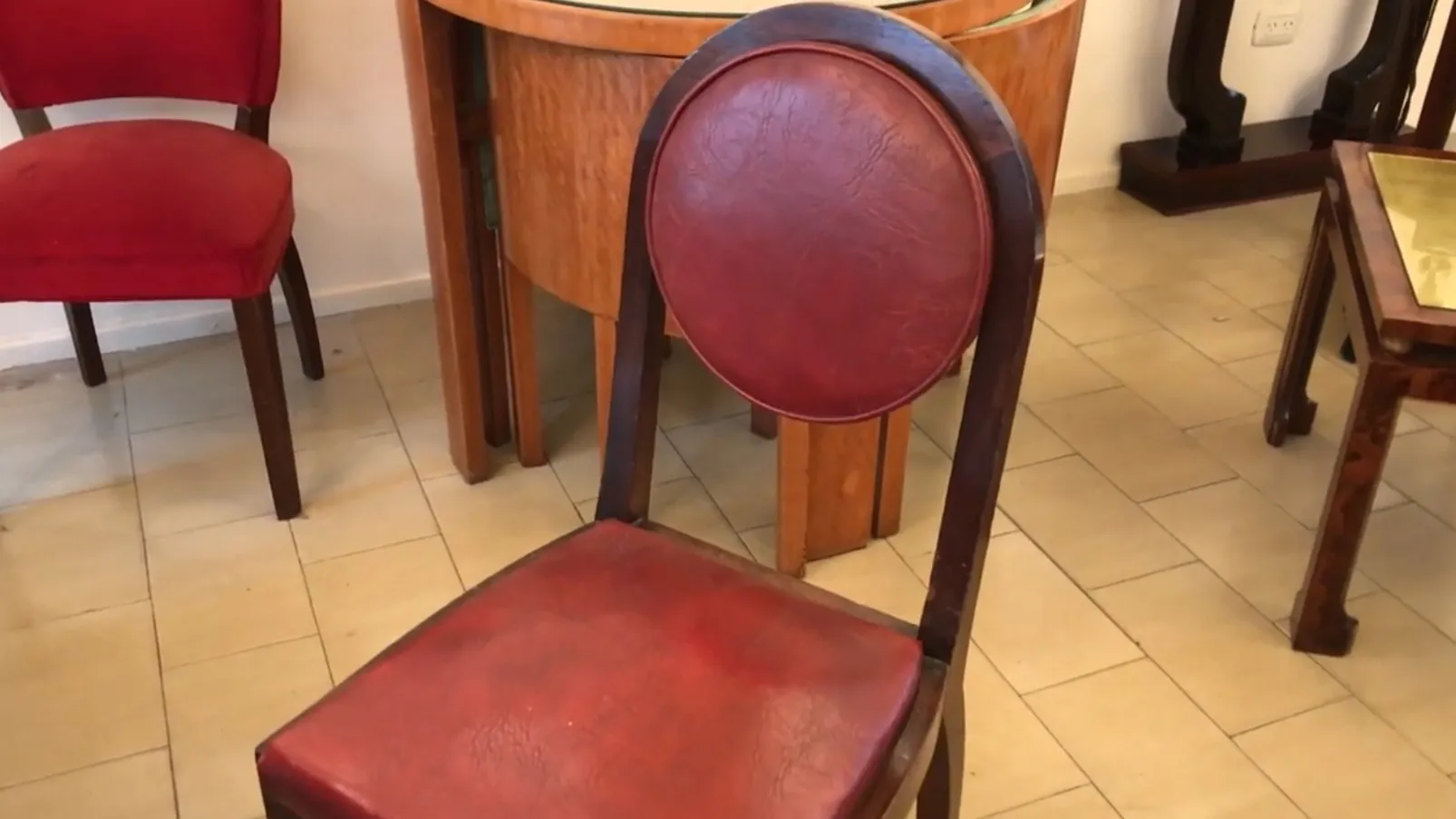 12 antique chairs in a rustic setting