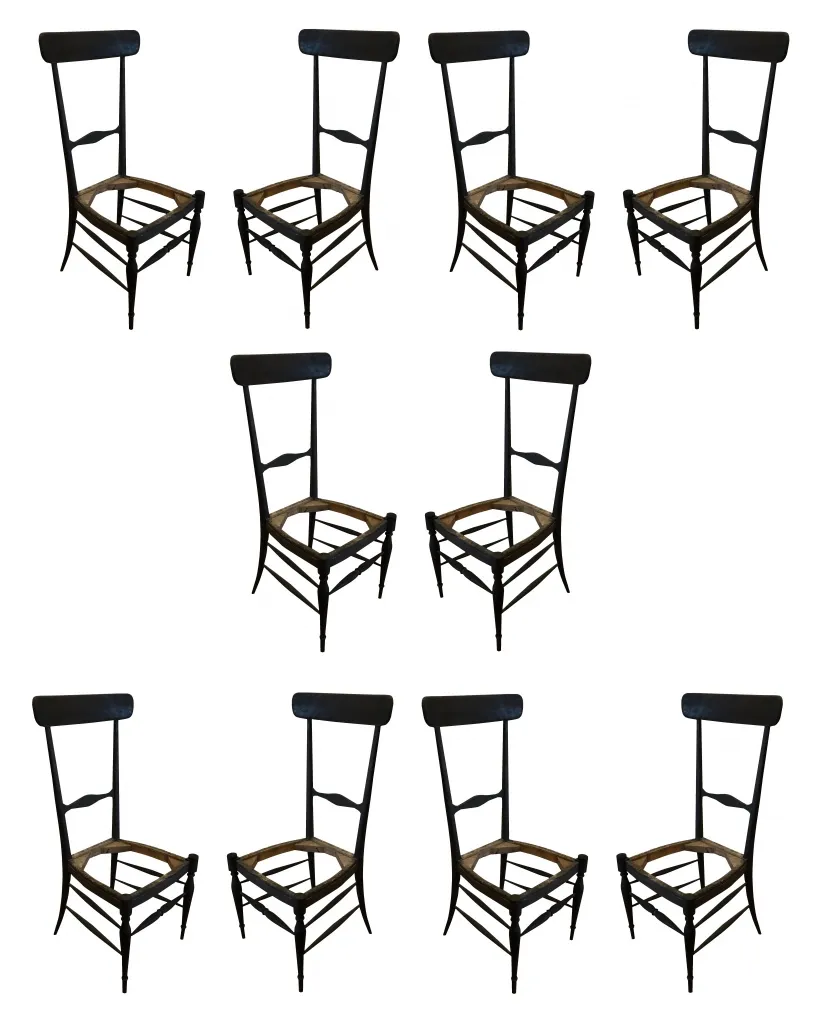 Set of ten antique chairs awaiting restoration.