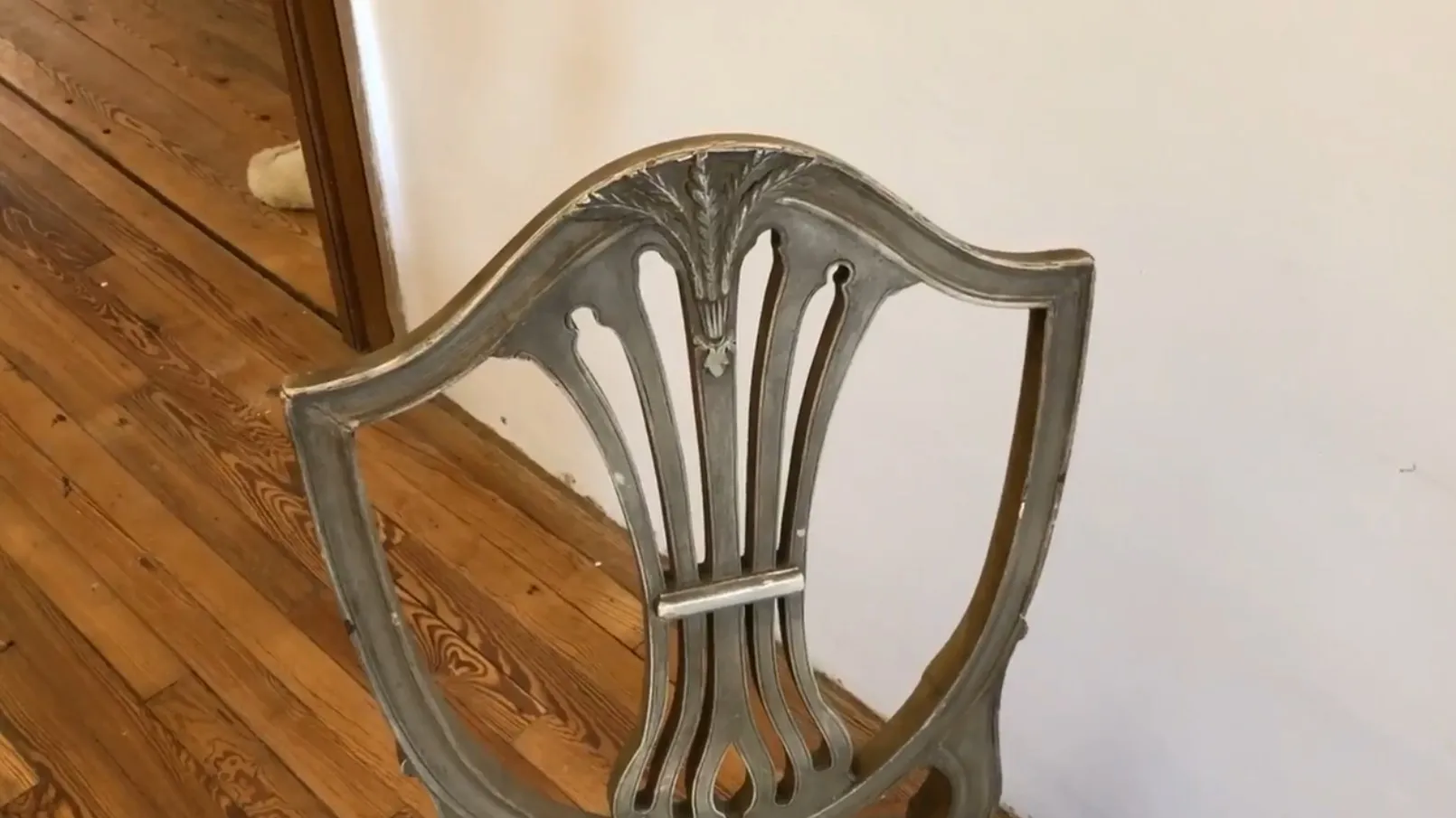 View of 10 antique chairs in a classic setting.