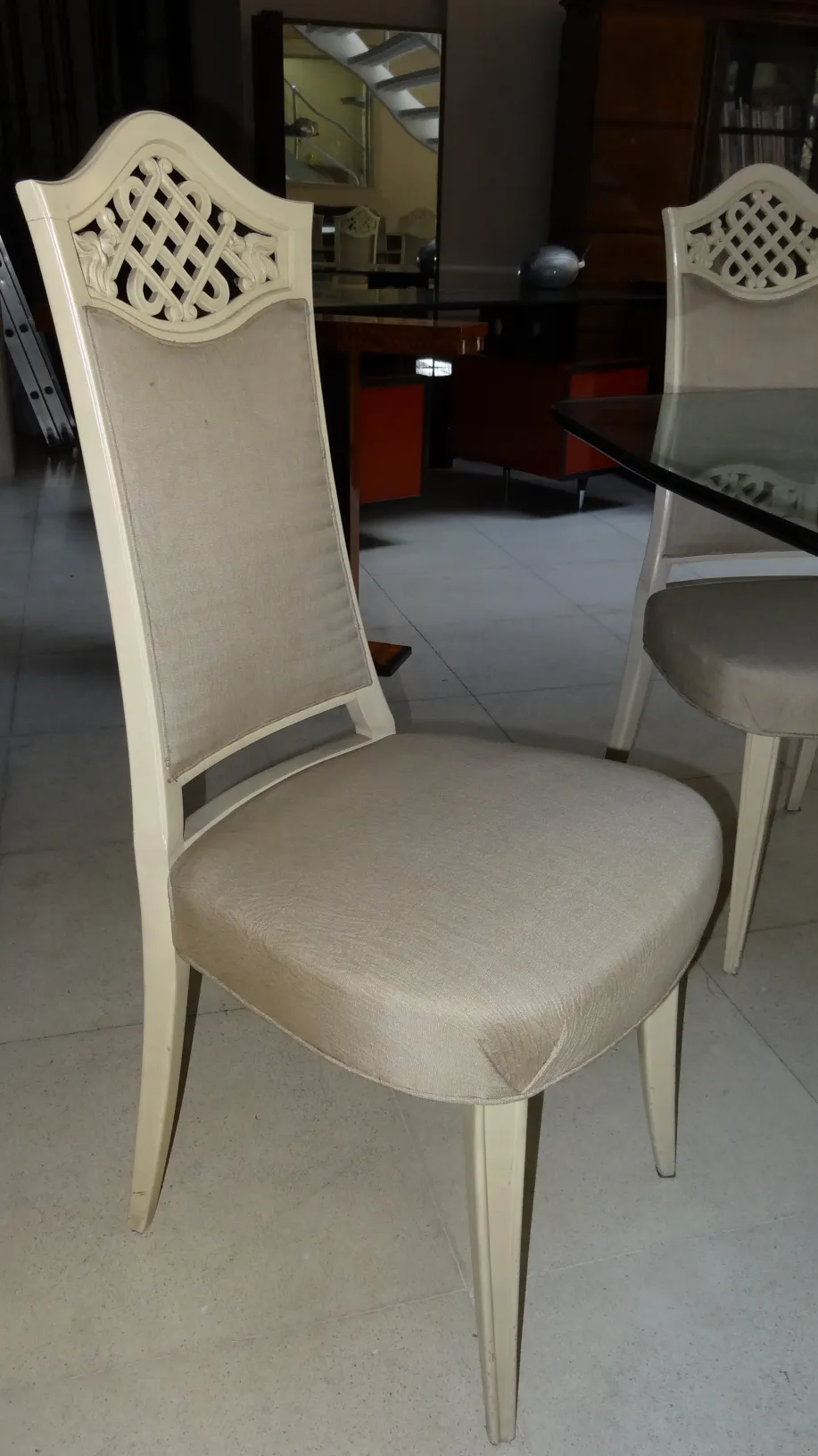 Room with 12 antique chairs to restore in the background.