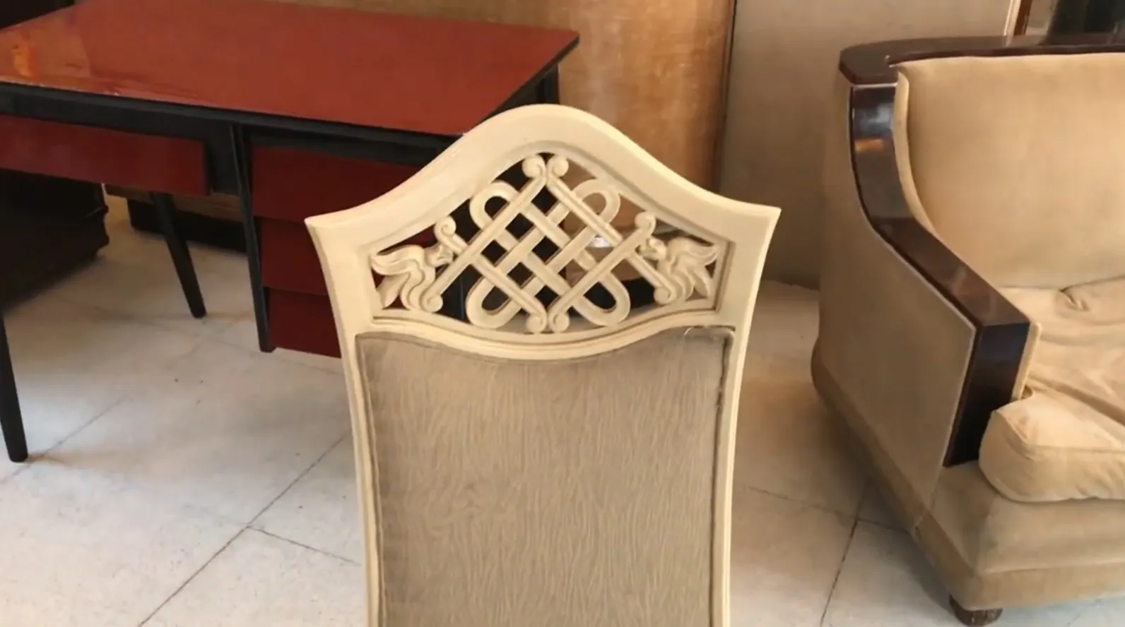 View of antique chairs in a restoration setting, back detail