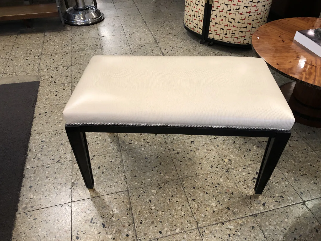 antique stool with light upholstery and elegant legs