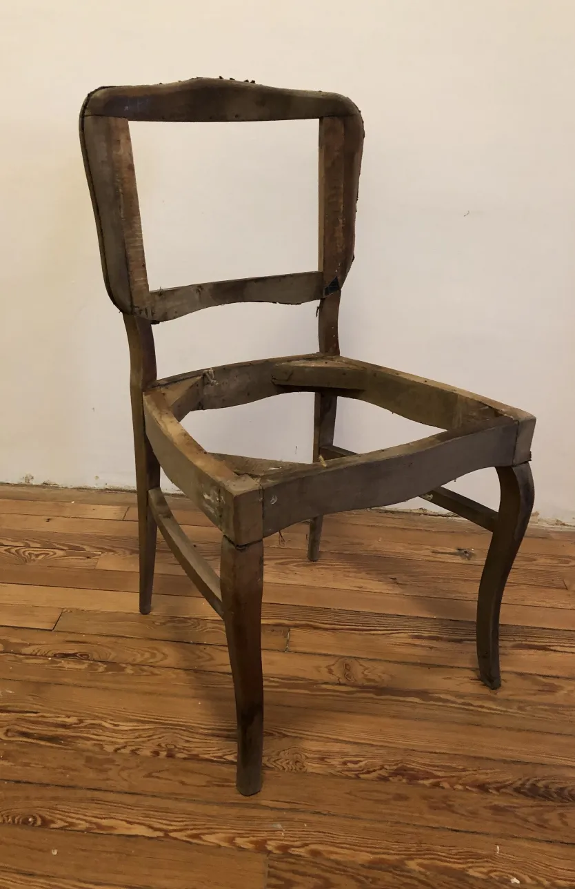 six antique wooden chairs in need of restoration, neutral background
