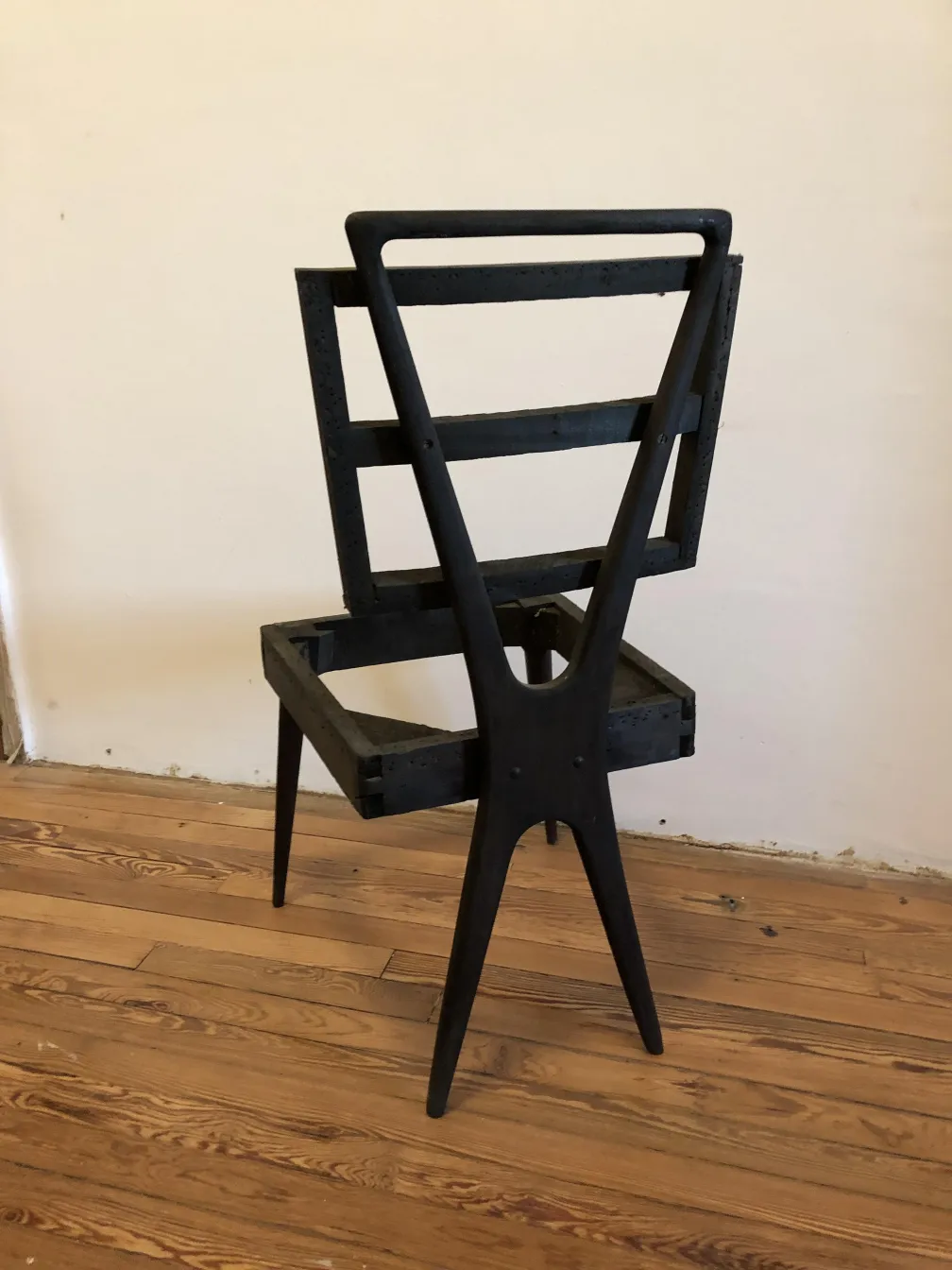 12 antique chairs in a restorative setting, visible signs of wear