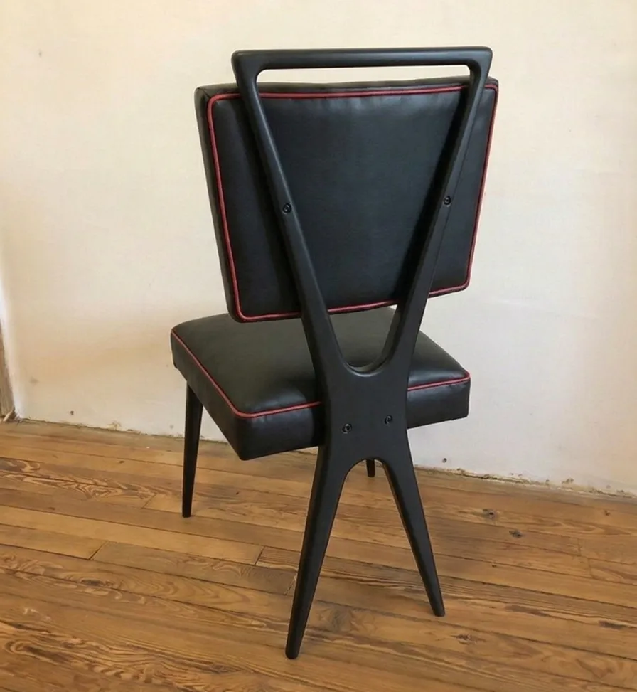 काली प्राचीन कुर्सी, लाल विवरण, तटस्थ पृष्ठभूमि।