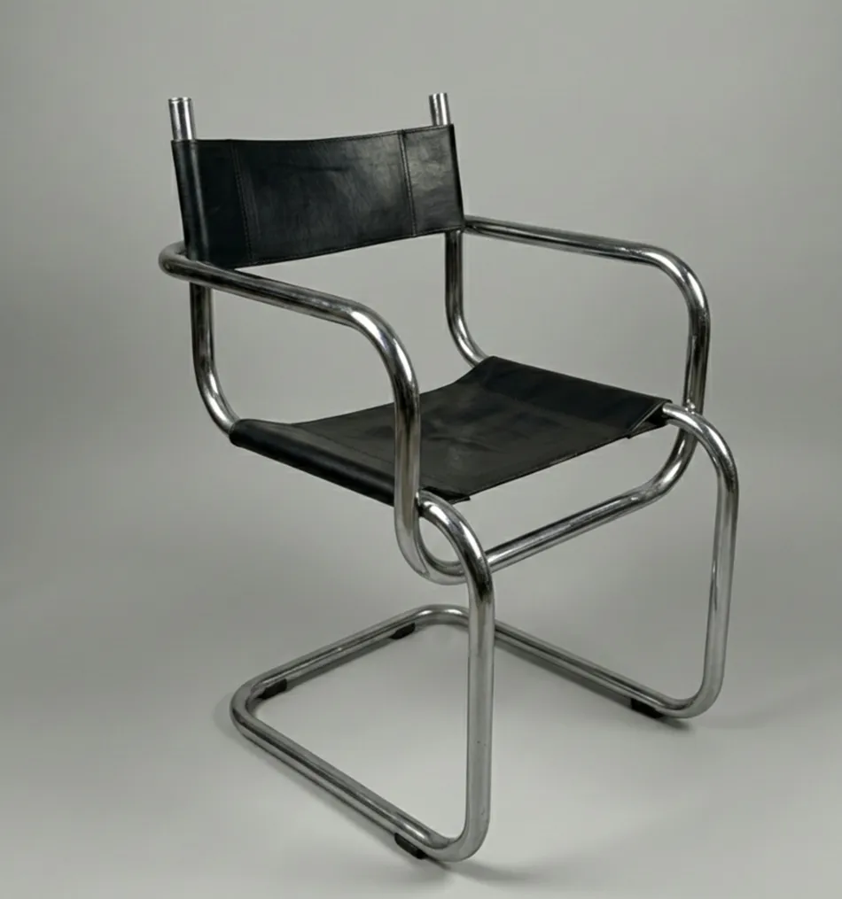 Four antique chairs with a modern and simple design in a neutral setting.