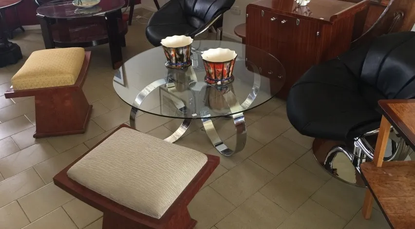 Accent stool with neutral upholstery, set in a modern room.