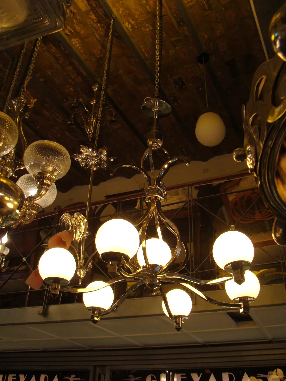 Antique hanging lamp Art Deco with spherical lights in a cozy setting.