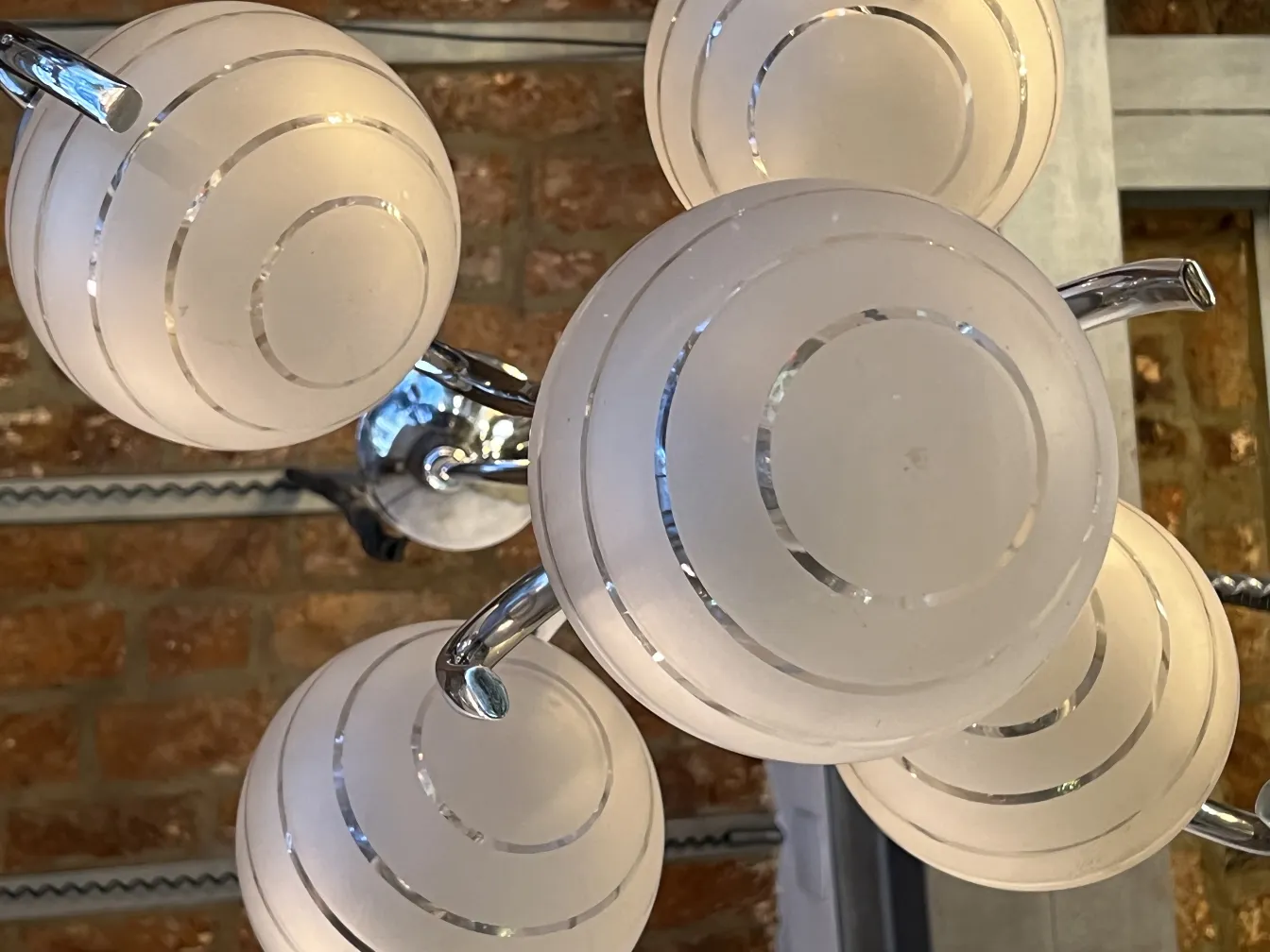 Antique hanging lamp with frosted glass balls, cozy atmosphere.