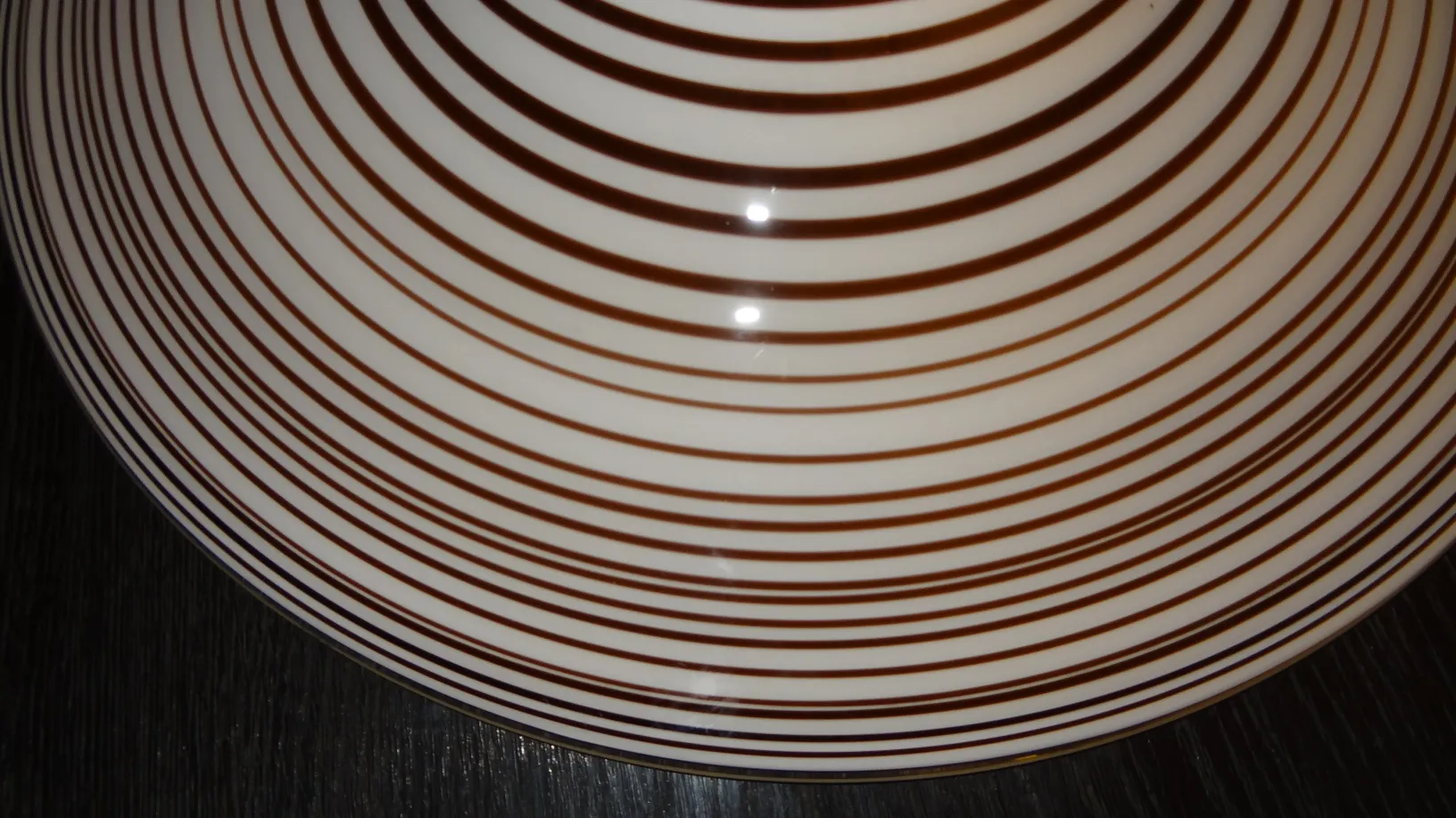 Antique hanging lamp with brown striped design, part of an elegant atmosphere.