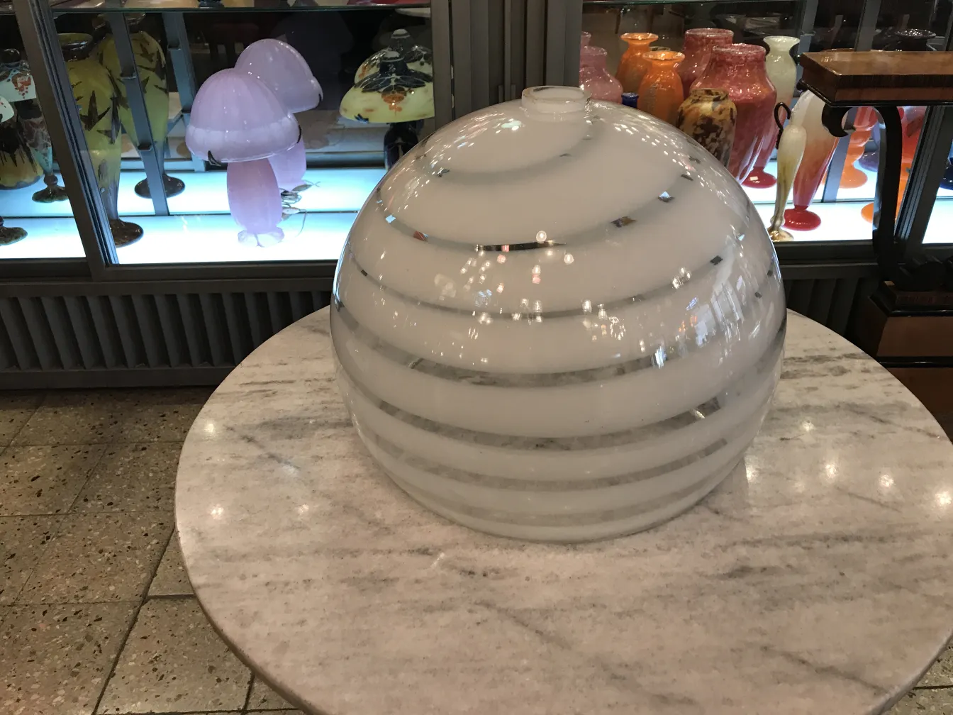 Antique hanging lamp paolo venini with elegant design and rounded shape on a table.