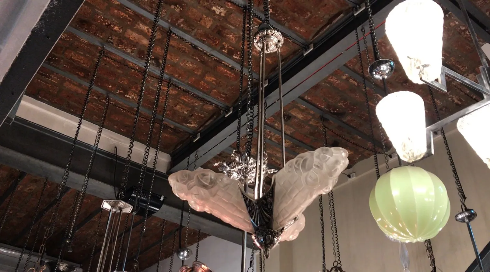 Antique hanging lamp with decorative base and elegant shapes in a cozy environment.