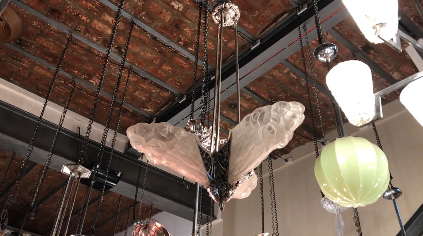 Antica lampada a sospensione in stile Degue con forma distintiva ed elegante in un ambiente accogliente.