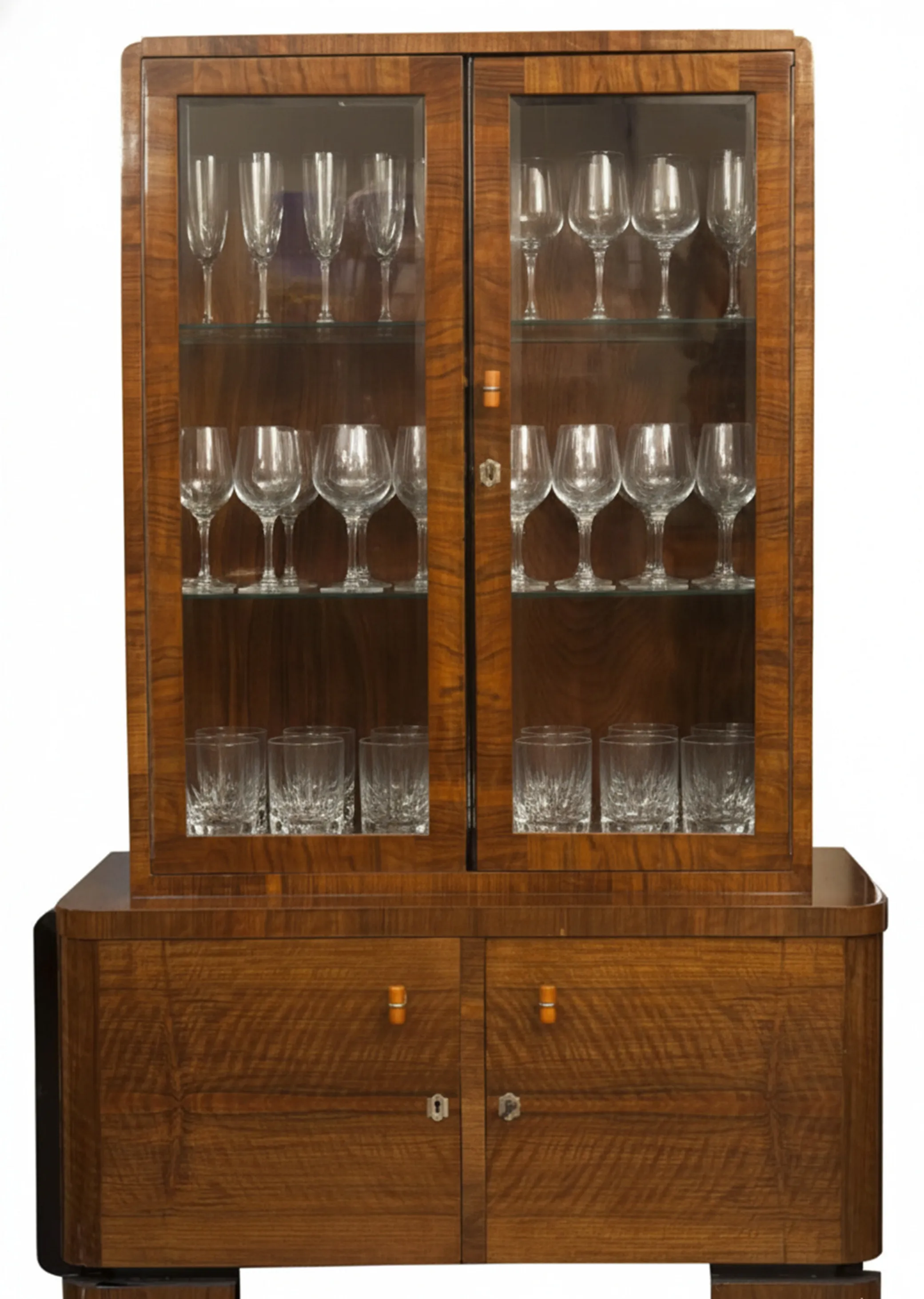 antique bookcase displaying glassware of various sizes