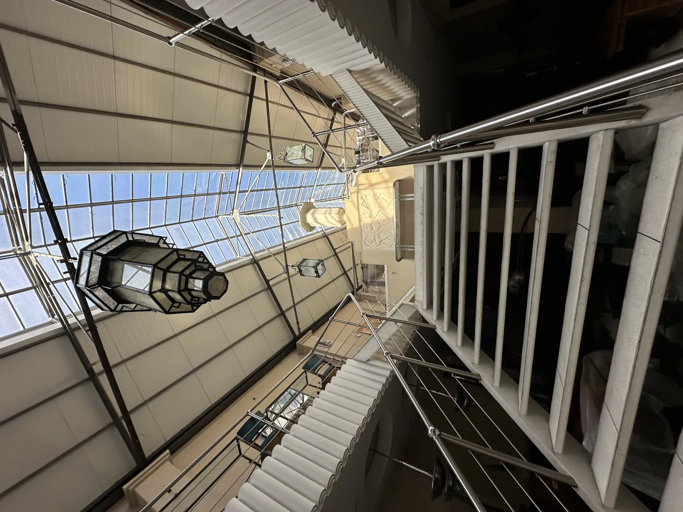 antique lantern hanging with intricate design in bright setting