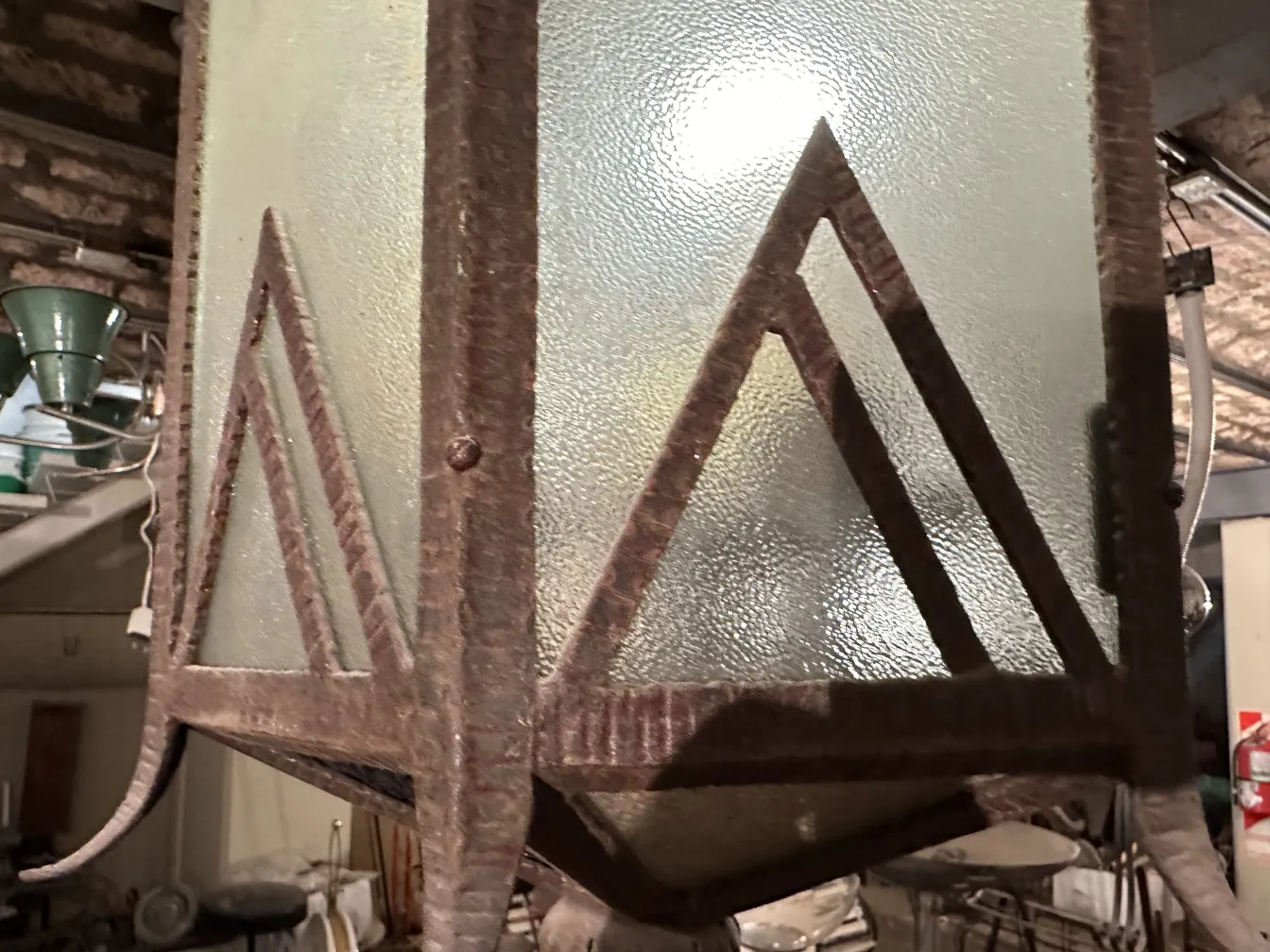 antique lantern with glass panels and triangular design