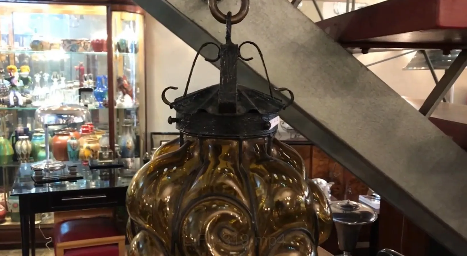 antique lantern with curved glass and metal structure, decorative background