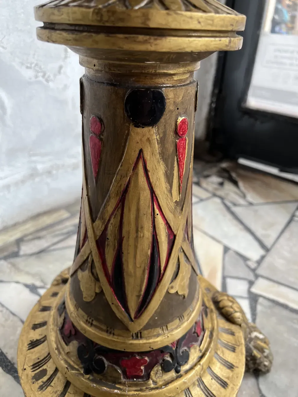 Antique sculpture with decorative gold and red details