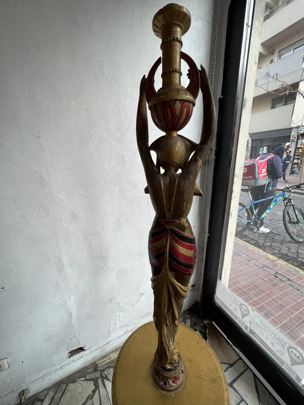 Antique sculpture with golden and red details, elegant.