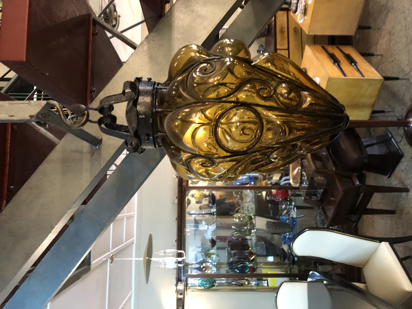 Antique brown glass lantern with ornamental design in a cozy setting