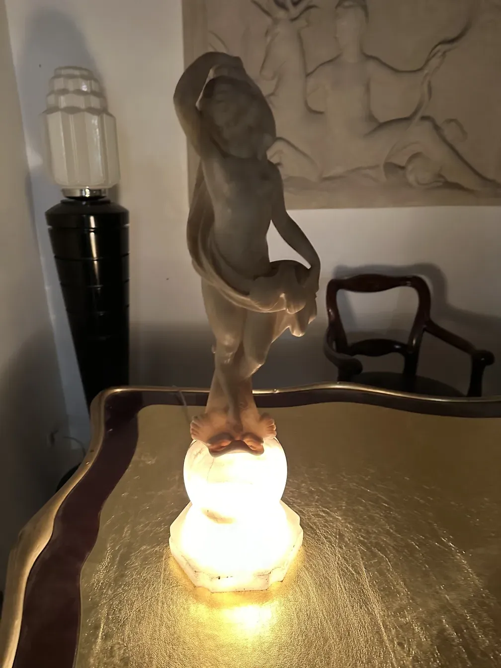 ancient sculpture of human figure with clear details, in a warm setting