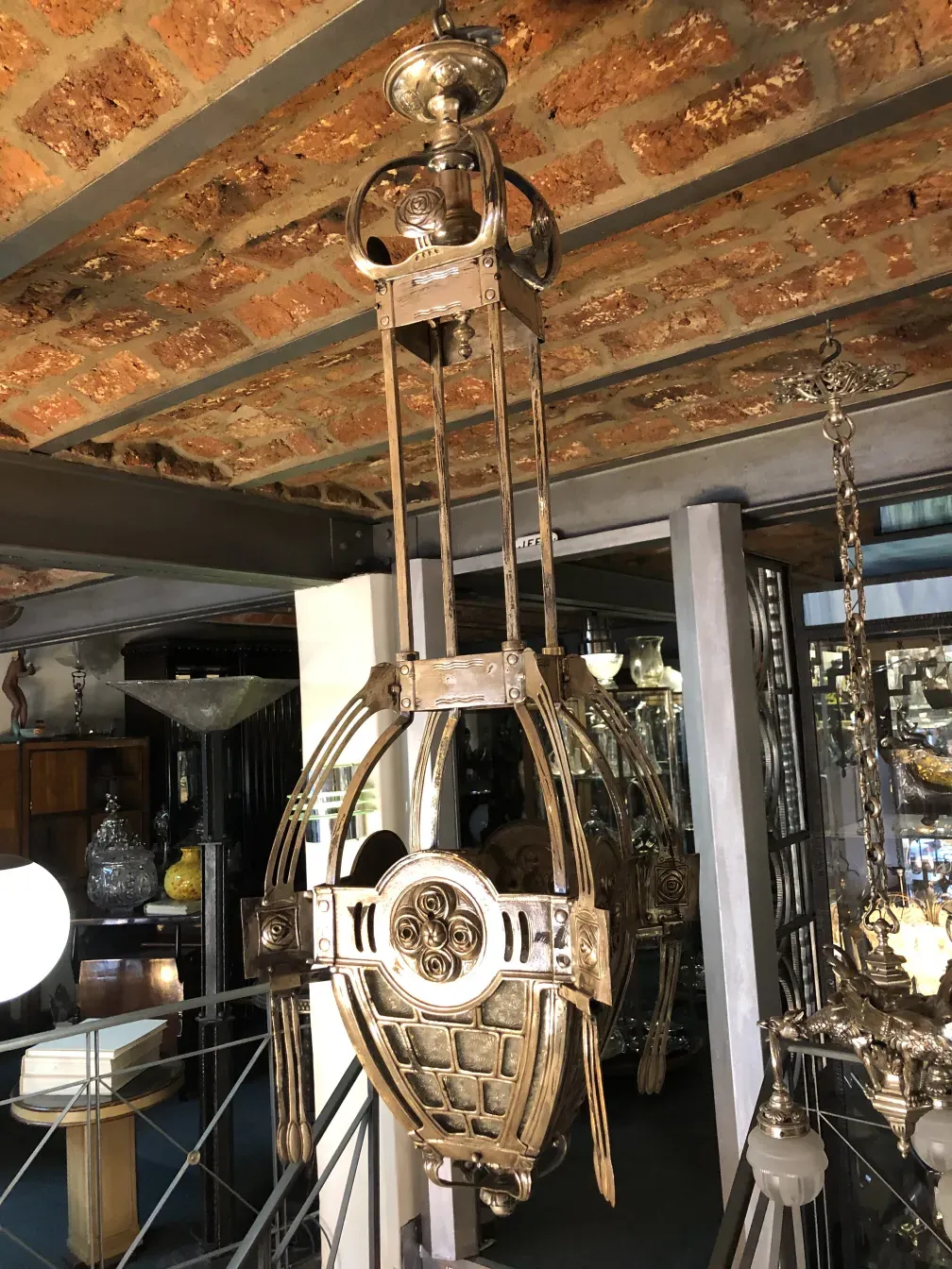 Ancien lustre mackintosh avec des détails uniques et un design élégant dans un cadre d'antiquités.