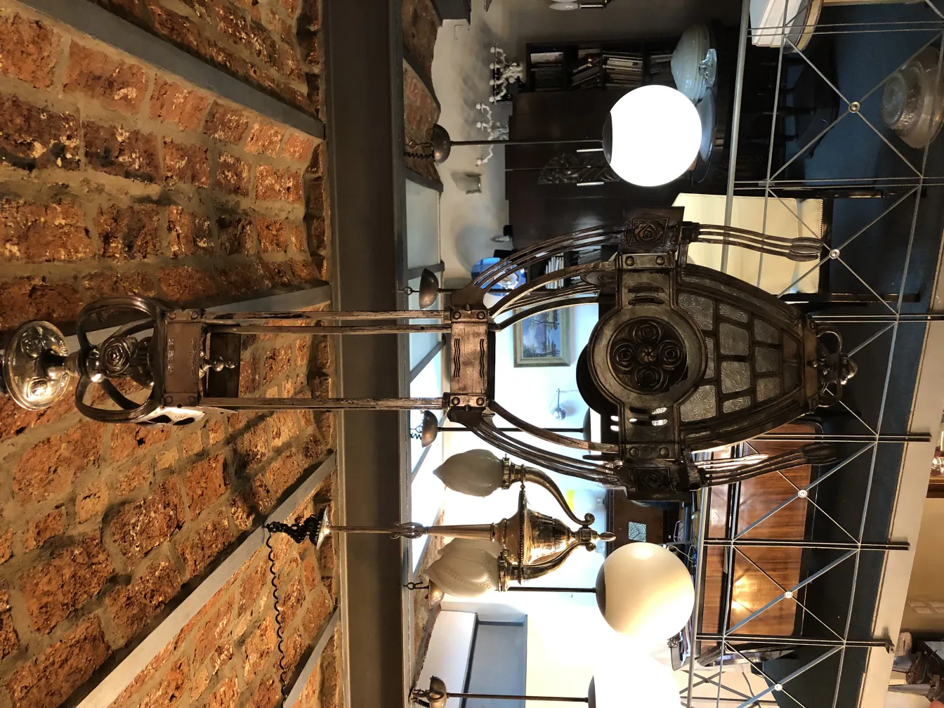 Antique wall lantern with decorative details in a modern setting.