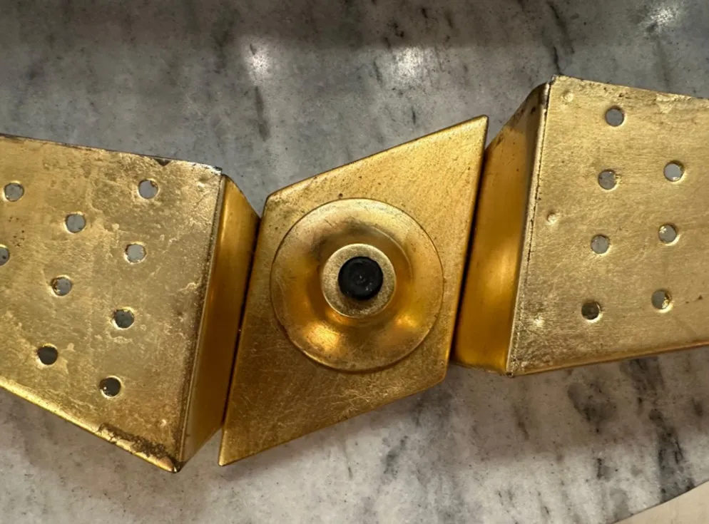 antique sconce with triangular golden design