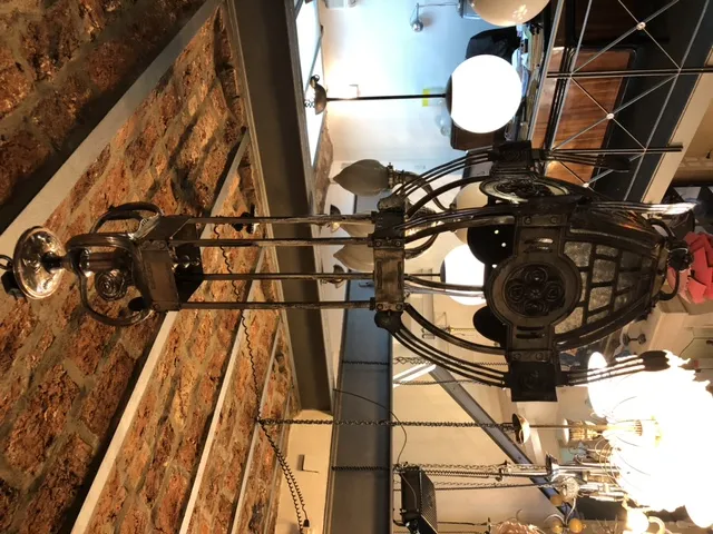 antique metal lantern with decorative details, displayed in a cozy environment