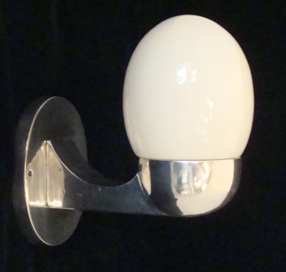 Antique sconce with an oval shape mounted on the wall.