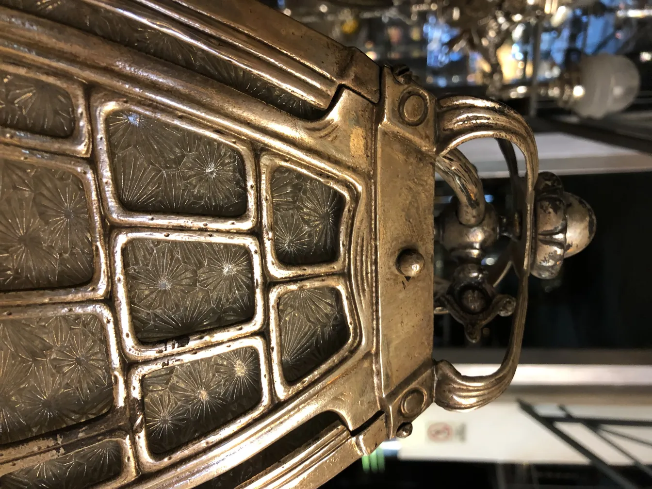 antique metal lantern with decorative glass, dark background