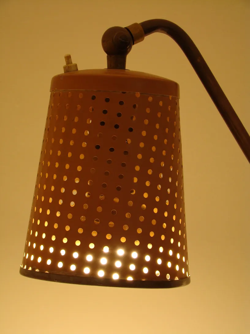 antique floor lamp with perforated shade, warm ambiance
