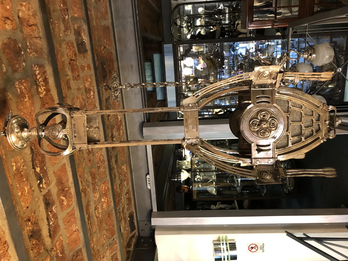 antique lantern with intricate design, hanging on a brick wall