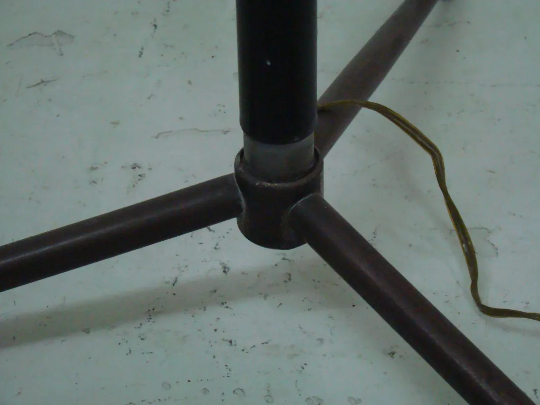 Base of antique floor lamp with art deco design, part of a warm setting