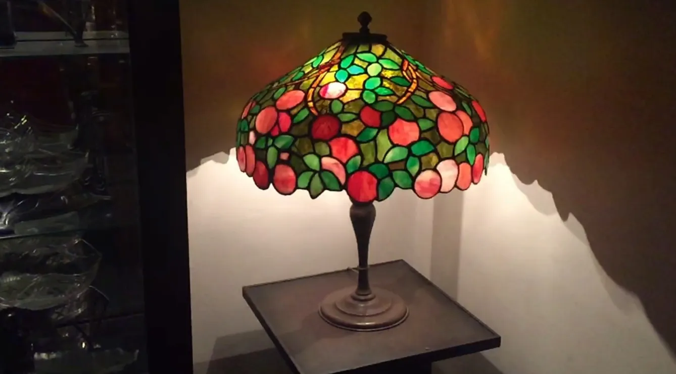 antique table lamp with colorful art deco design, illuminating a soft atmosphere.