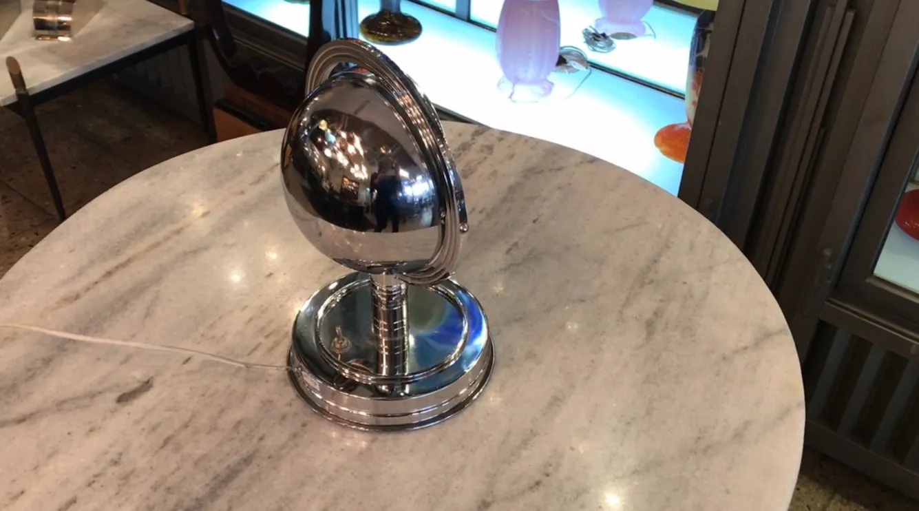 antique table lamp with a shiny base and oval shape in an elegant setting