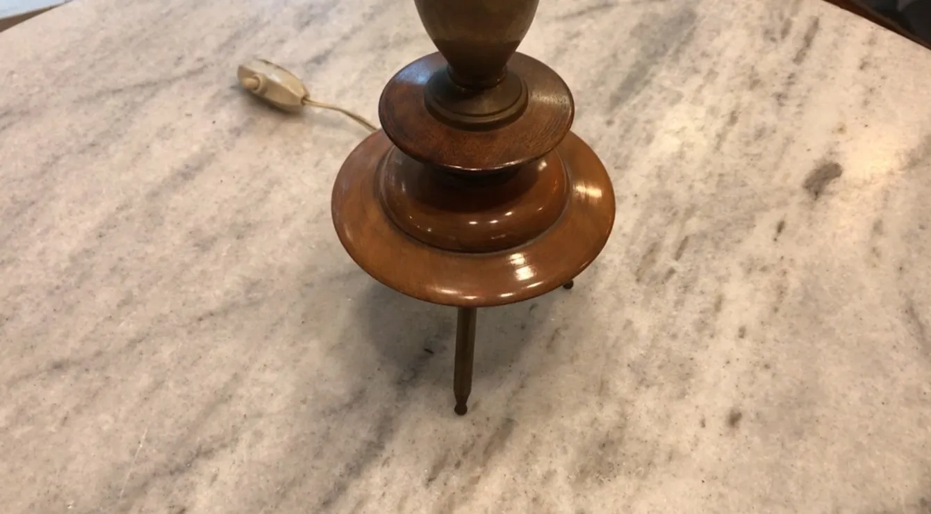 Antique table lamp in Art Deco style on a light-colored surface.