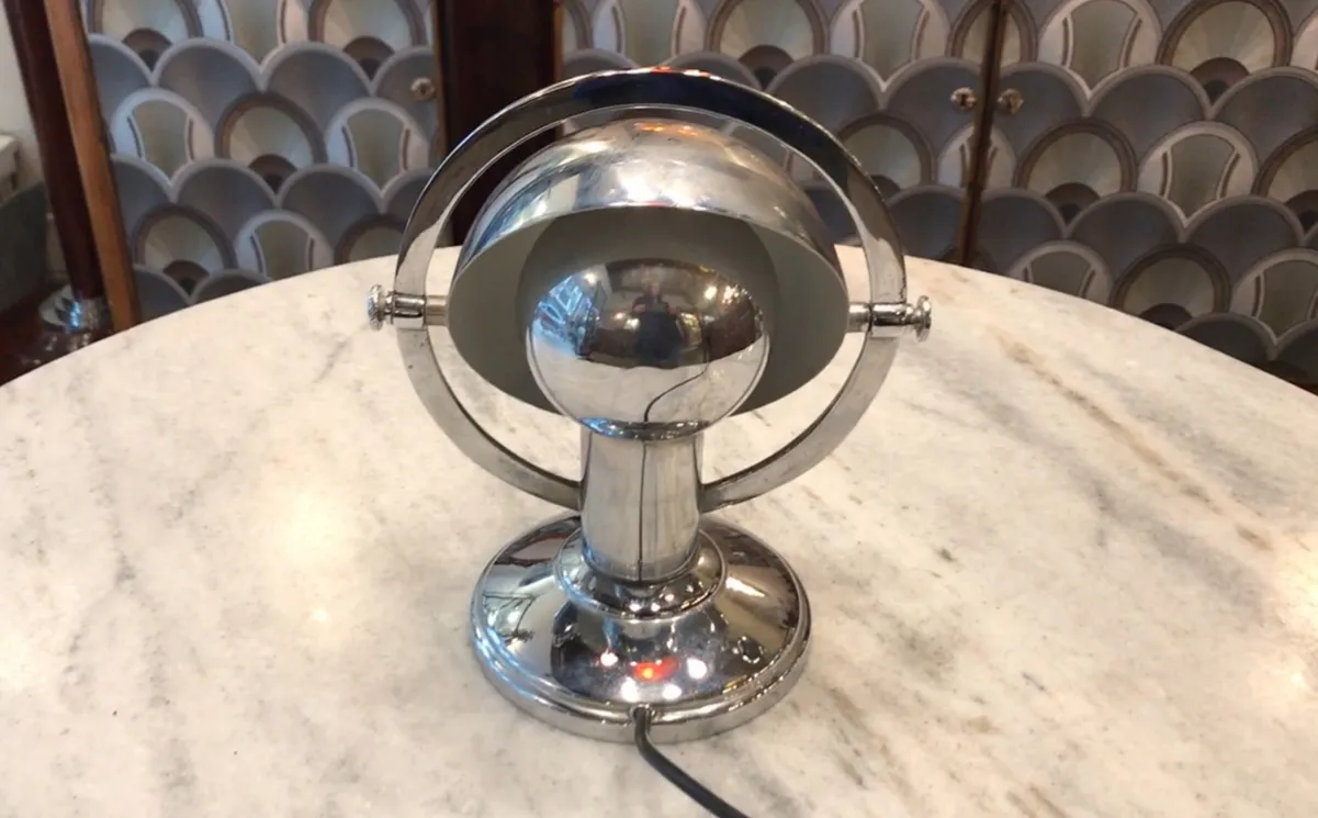 Antique table lamp Art Deco, spherical shape with shiny base, designed background accessories.