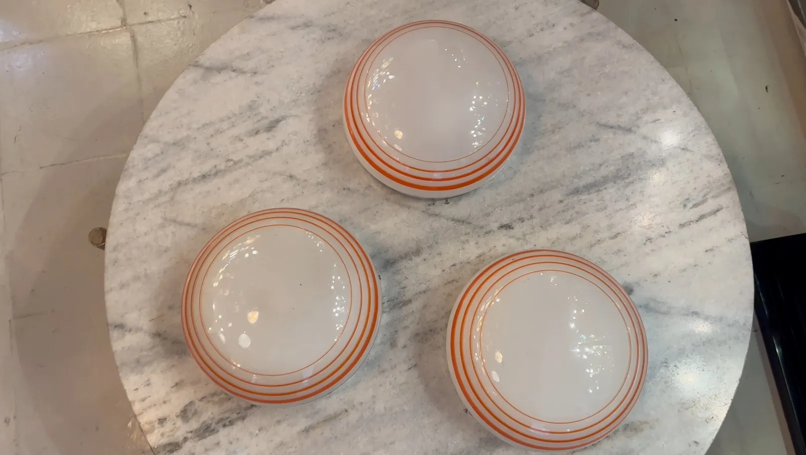 Three antique ceiling lights with round shapes and lines