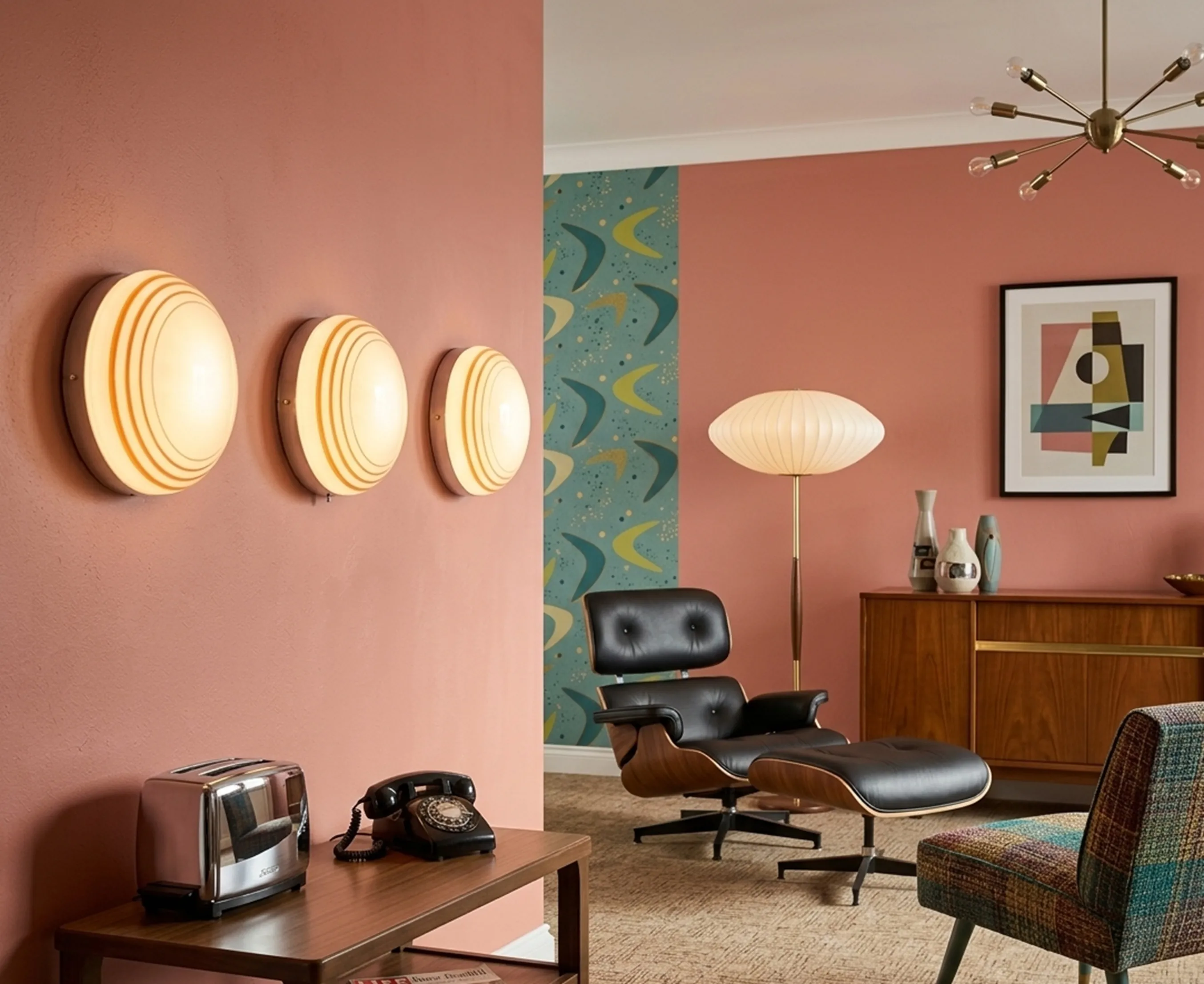 three antique ceiling lights on a pink wall