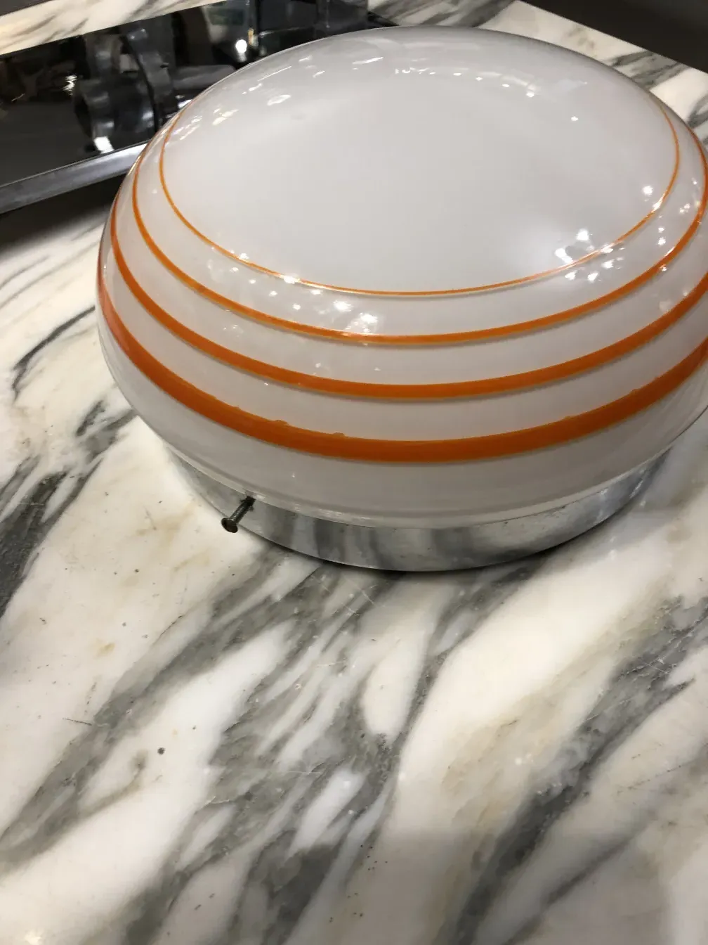 Three antique ceiling lights with round shape and orange lines