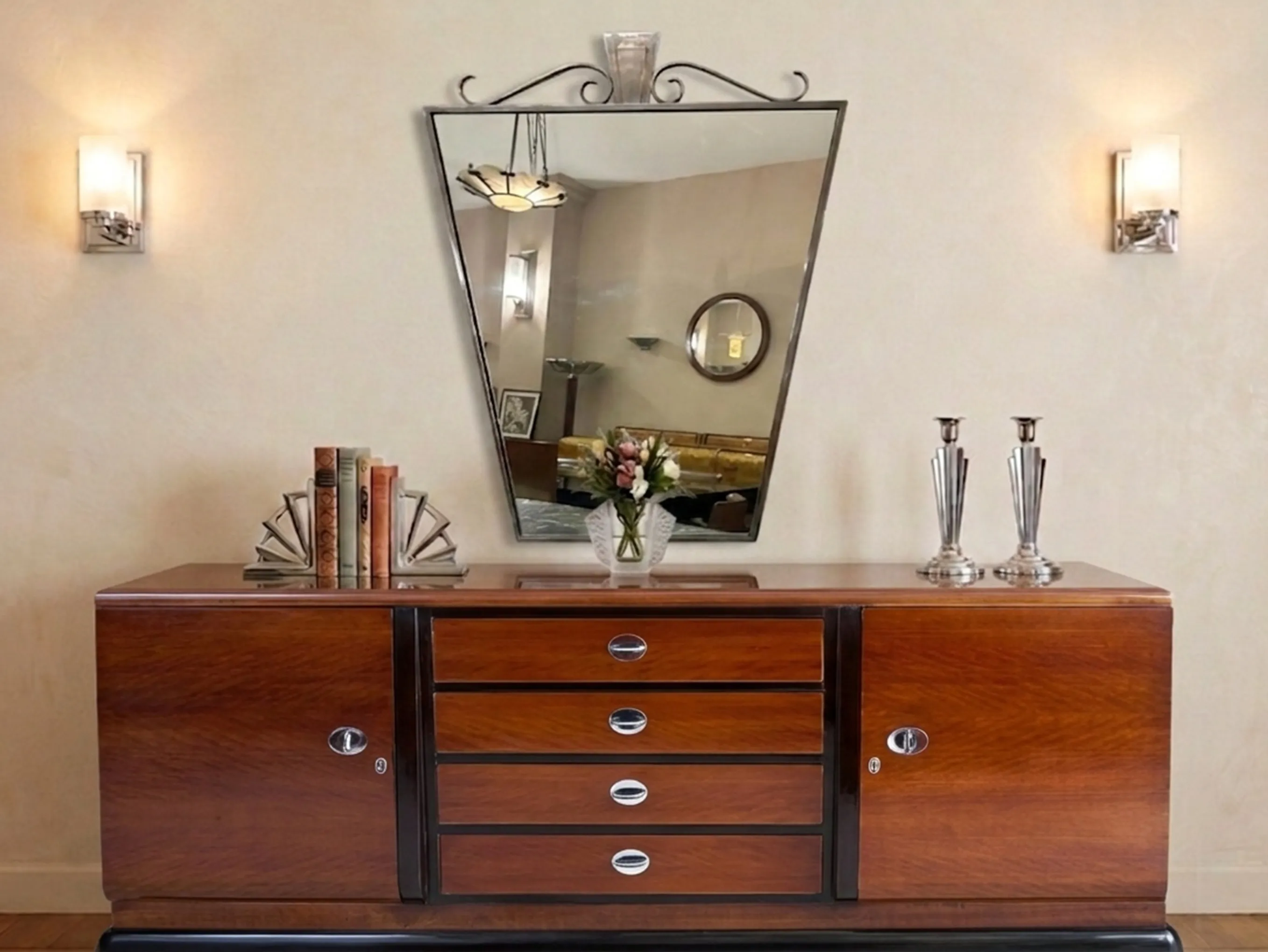 antique mirror with decorative shape on a dresser with items