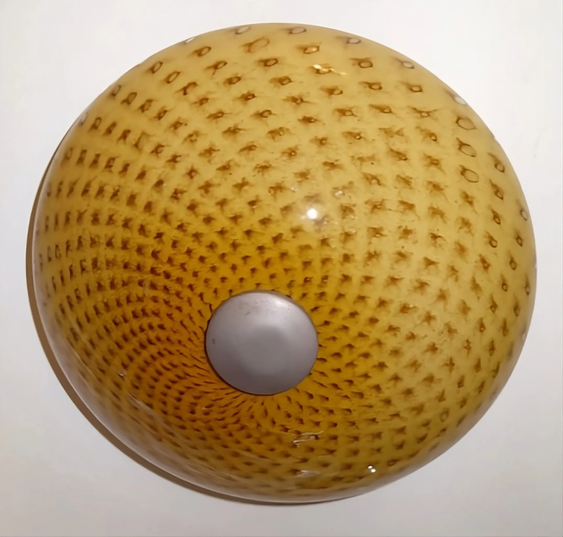 plafonnier ancien avec design texturé et couleurs chaudes