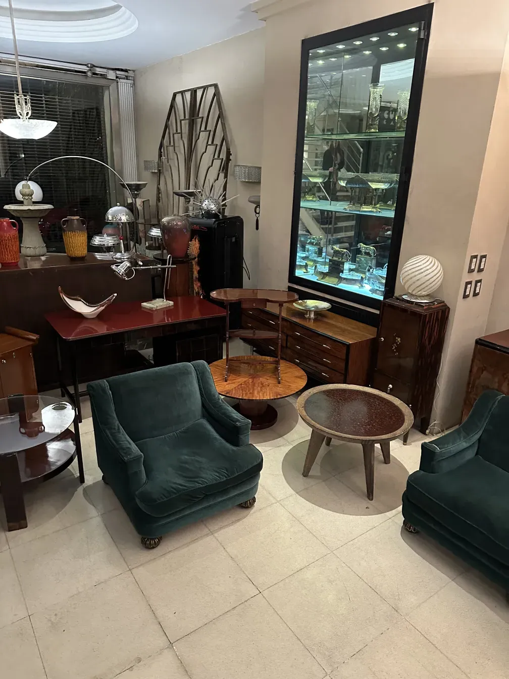 antique coffee table charlotte perriand in an elegant setting with green armchairs