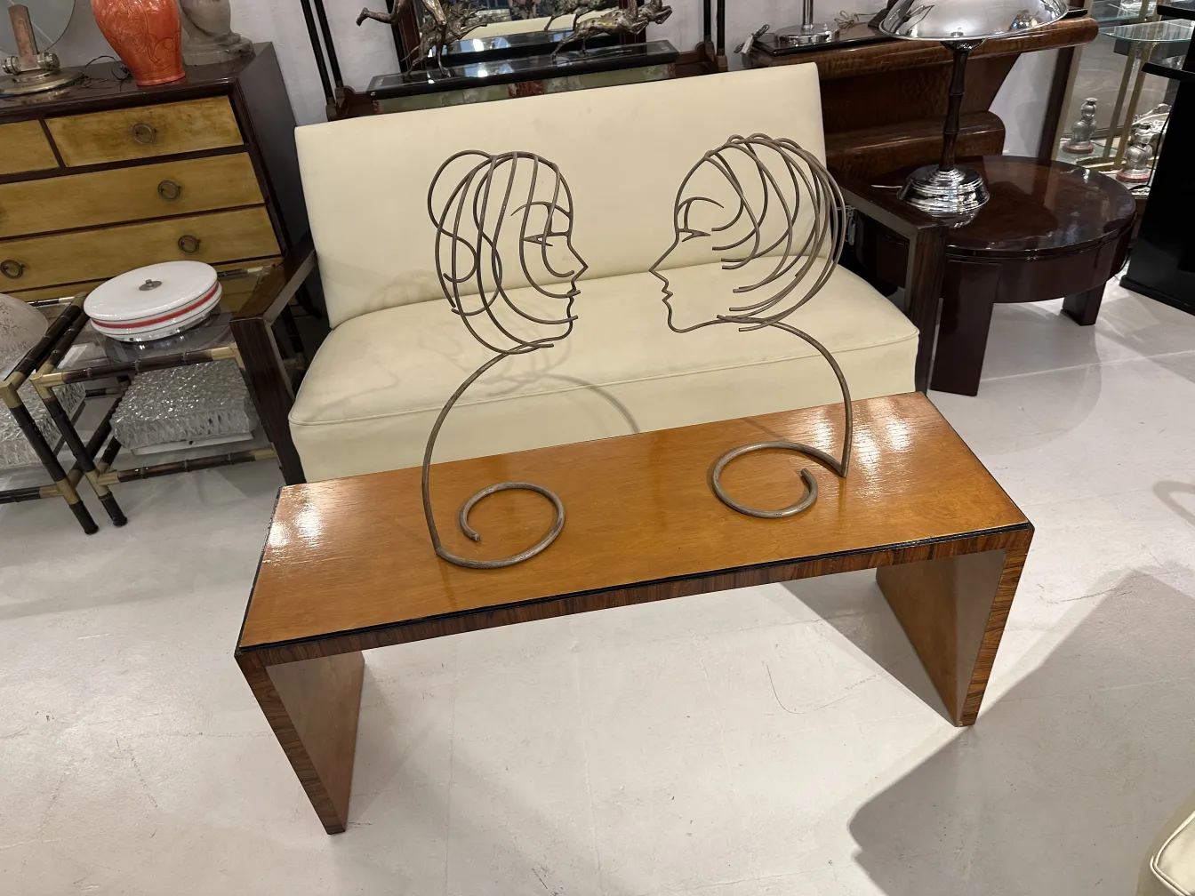 antique coffee table featuring a decorative figure