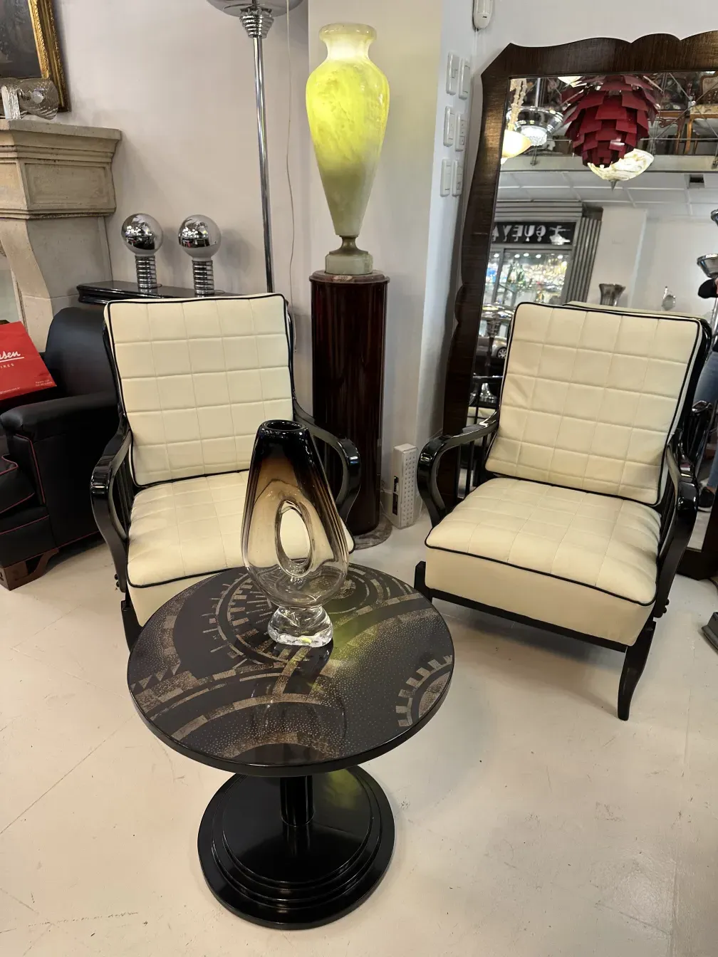 antique small table with a circular design and elegant base, adorned with clear visual details, surrounded by chairs