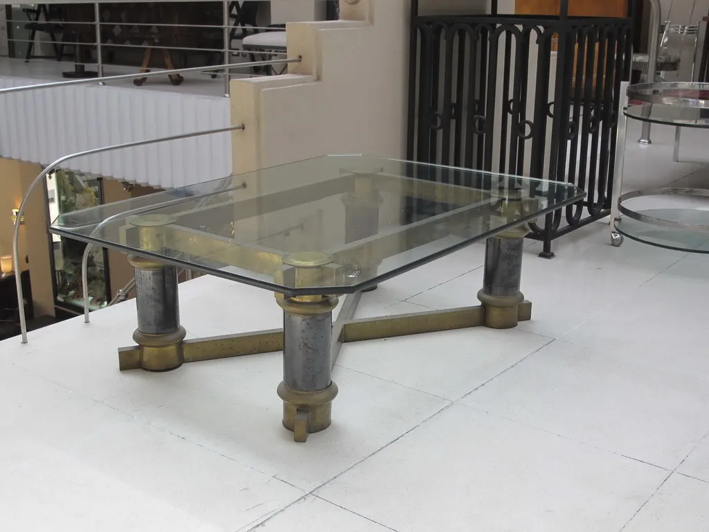 Antique coffee table with glass top and decorative legs in a modern setting