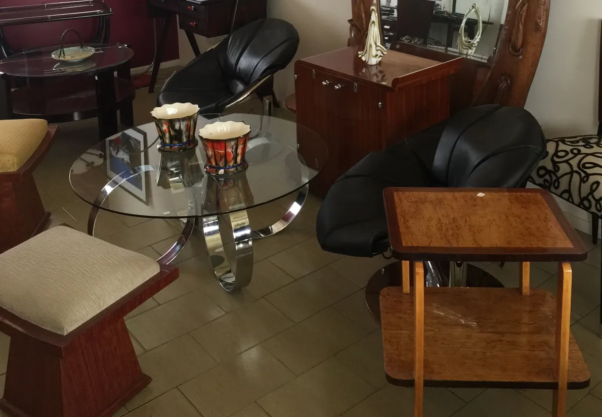 Antiker Couchtisch im Art Deco-Stil in einer gemütlichen Umgebung mit Stühlen und Dekoration